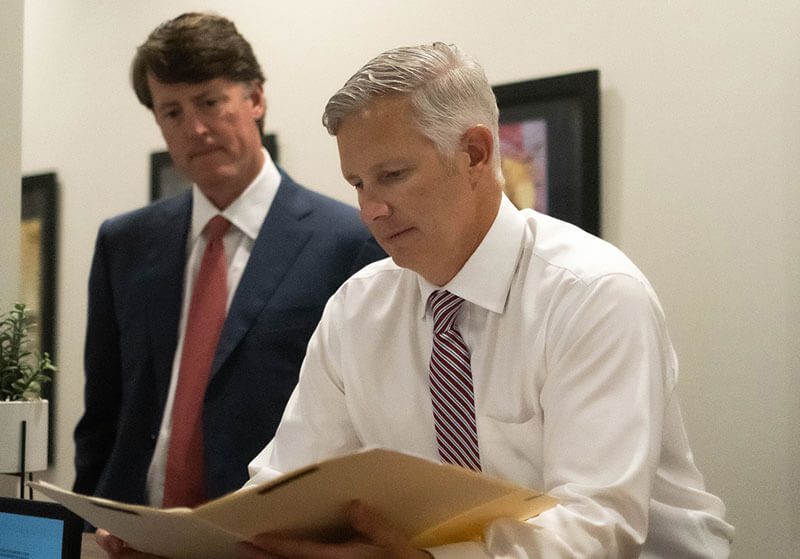 Terry and Thweatt looking over a case